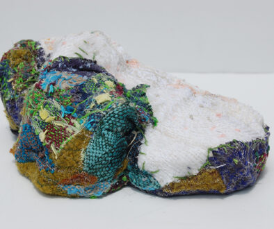 "Lifted Lithium II" by Deborah Kuster (c) - 4"h x 10"w x 7"d - handwoven textiles, styrofoam, embroidery thread